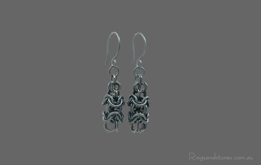 Black chainmaille earrings with garnet beads
