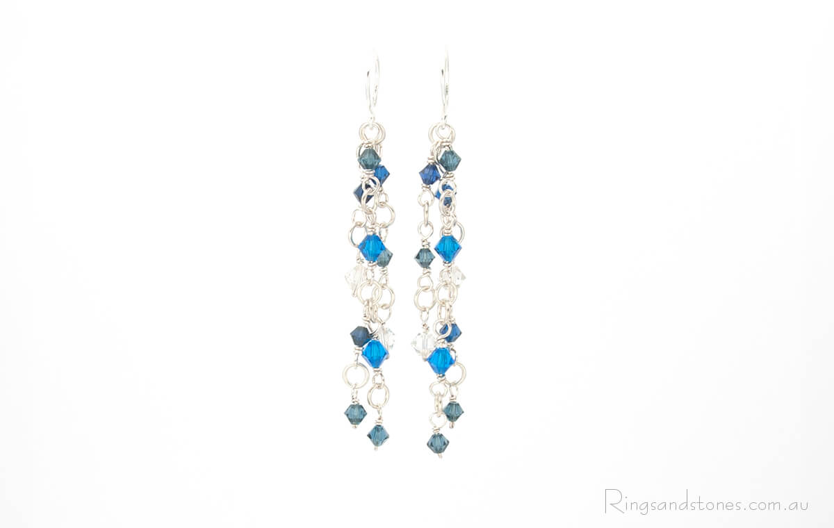 Sparkling suspended blue Swarovski crystals with detailed silver wire wrapping. Original artisan earrings.