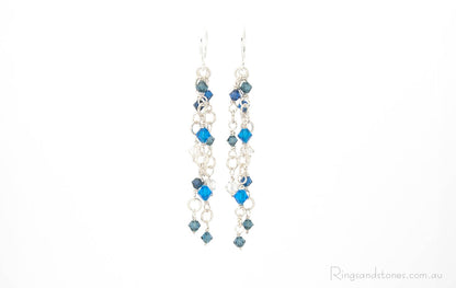 Sparkling suspended blue Swarovski crystals with detailed silver wire wrapping. Original artisan earrings.