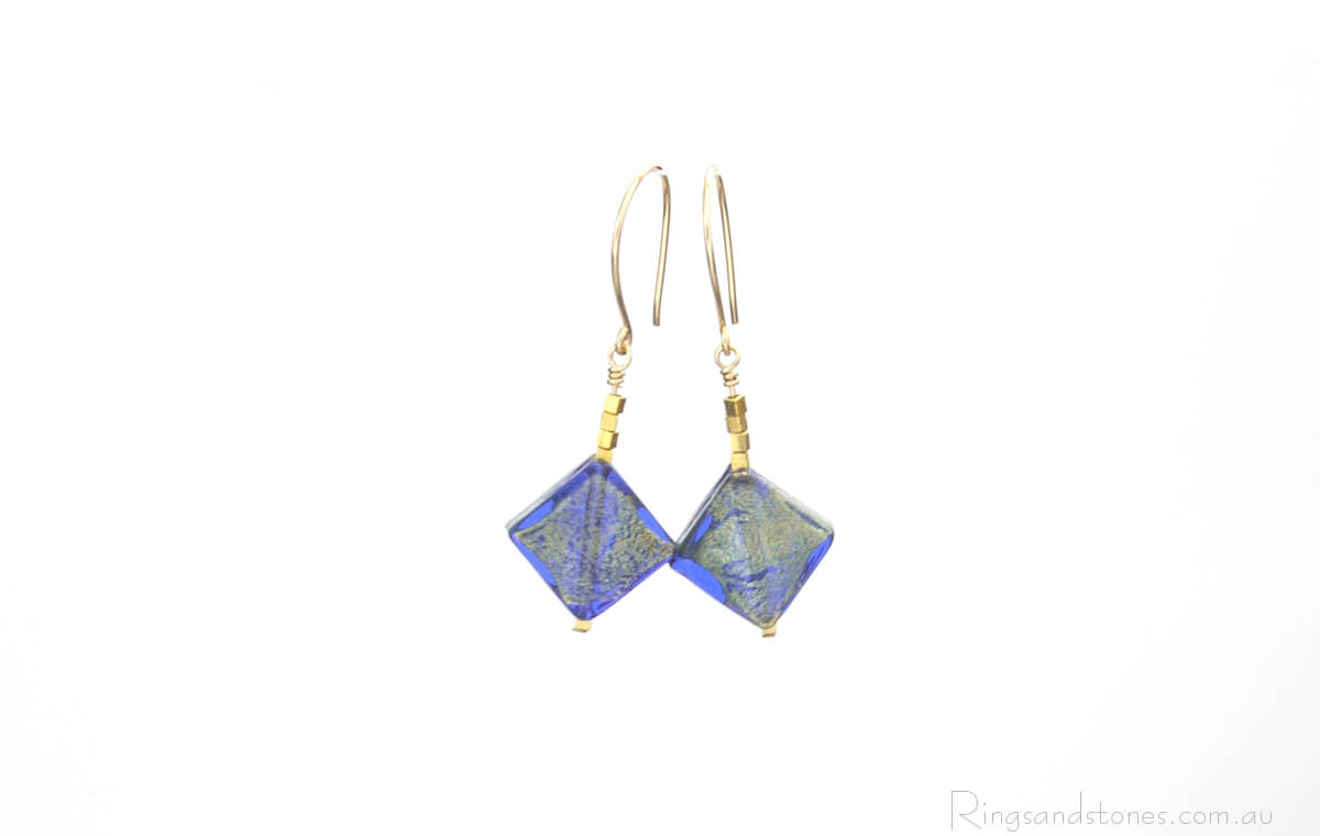 Murano glass gold earrings with gold and blue diamonds.