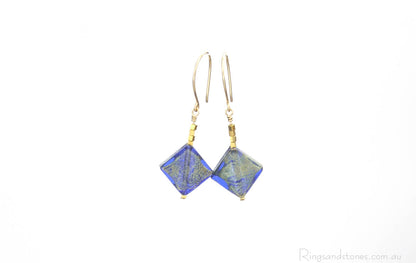 Murano glass gold earrings with gold and blue diamonds.